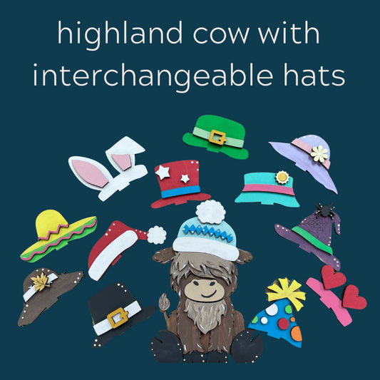 Highland cow with interchangeable hats